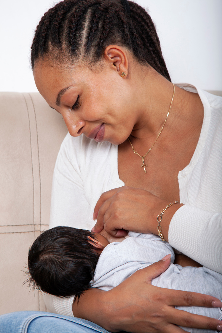 African American Woman Breastfeeding A Newborn Baby